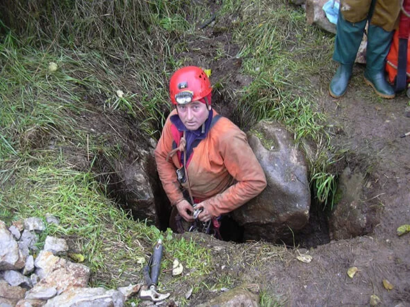 Speleologist Paolo Forconi entering the upper entrance of Grotta Antica, artificially widened